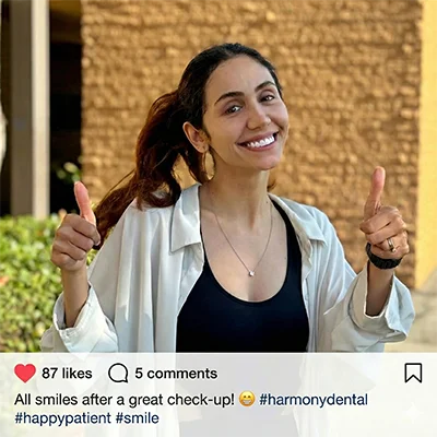 A happy, smiling patient standing outside the Pure Santa Ana Dentist clinic after a comfortable and successful dental visit